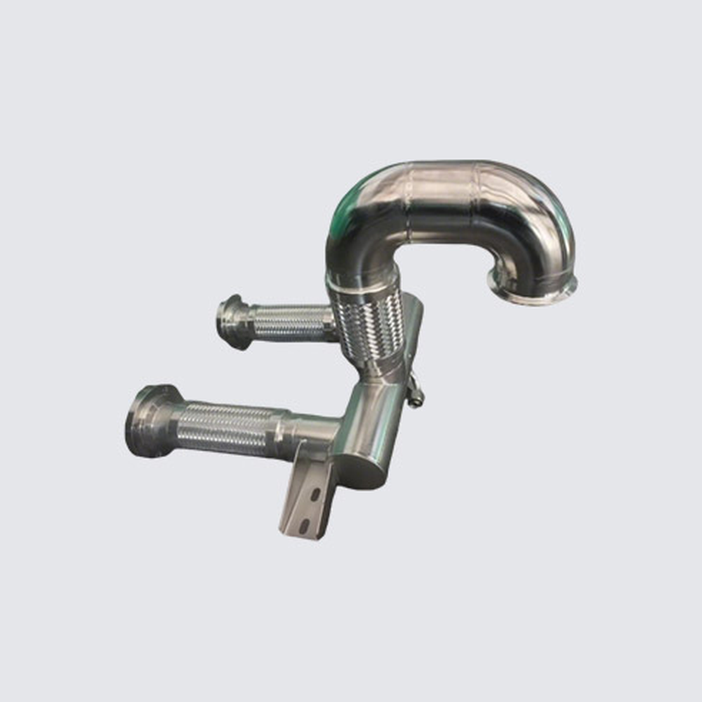 Deya formed metal system-pipe module with a return bend, flexible branches and a mounting lug; drawing-defined reference.